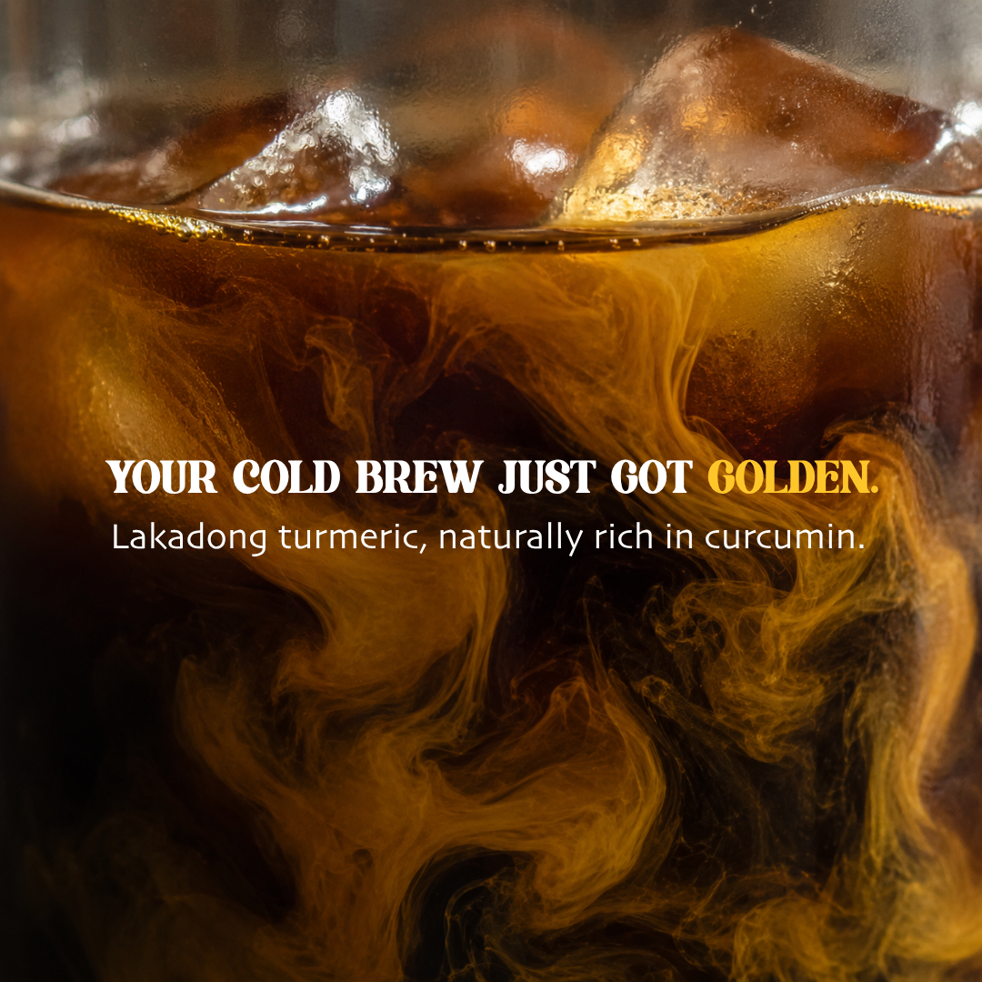 Close-up of Lakadong turmeric swirling through iced cold brew coffee
